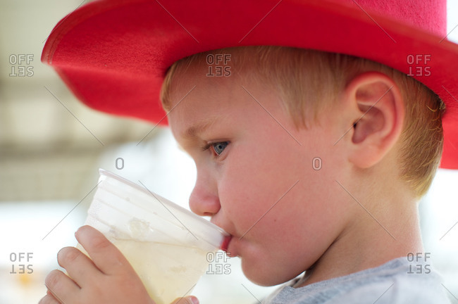 A boy drinks lemonade on the Fourth of July