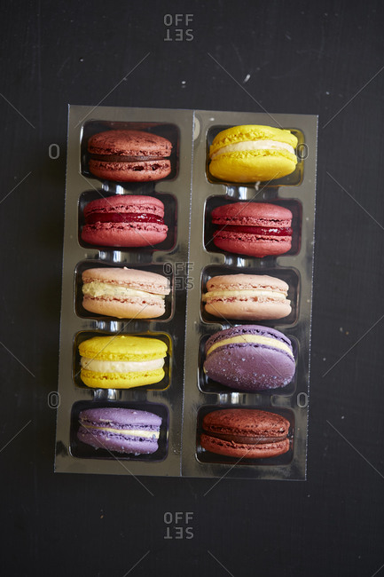 Several macarons in plastic container