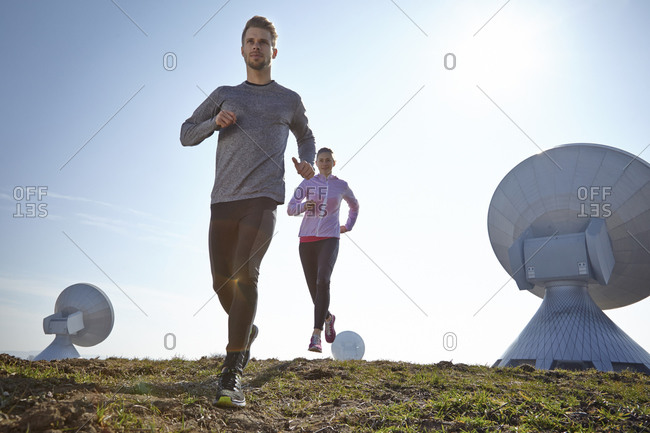 Young couple jogging at a ground station