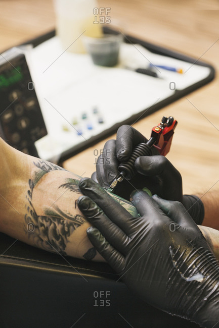 Hands of a tattoo artist working