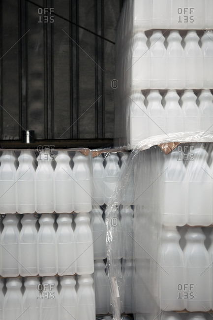 Stacks of plastic juice bottles in a commercial juicery