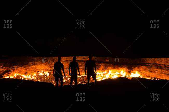 People standing at the Door to Hell gas field in Turkmenistan