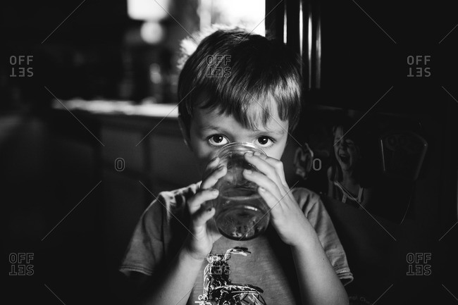Young boy drinking from a jar