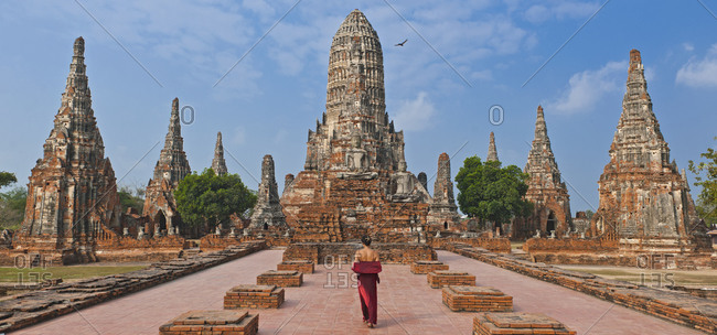 Woman in red dress at the ancient temple of Wat Chaiwatthanaram in Ayutthaya