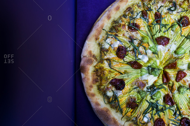 Vegetarian pizza with goat cheese and zucchini flowers