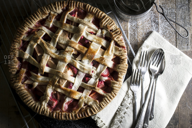 Homemade strawberry apple pie served on a wood table