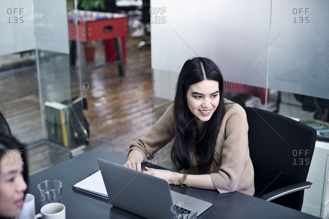 Woman with open laptop during meeting