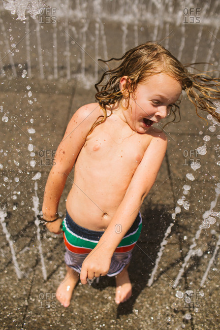 Boy having fun at a splash pad