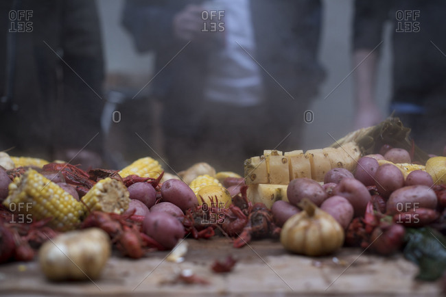 Table of steaming crayfish, potatoes and corn