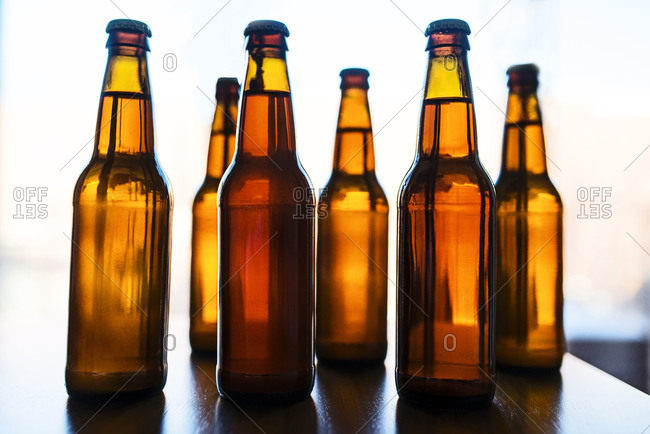 Six brown beer bottles without labels