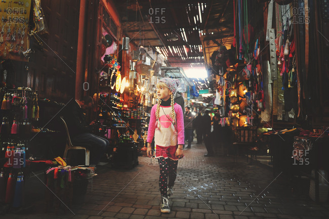 Young girl walking in a Moroccan souk