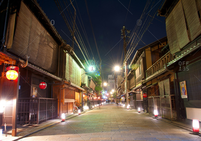 Brightly lit street scene at night in Kyoto