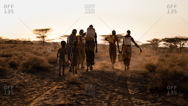 Families head home after fetching water from a borehole in Northern Kenya, Africa