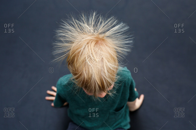 Static electricity in boy\'s hair from above