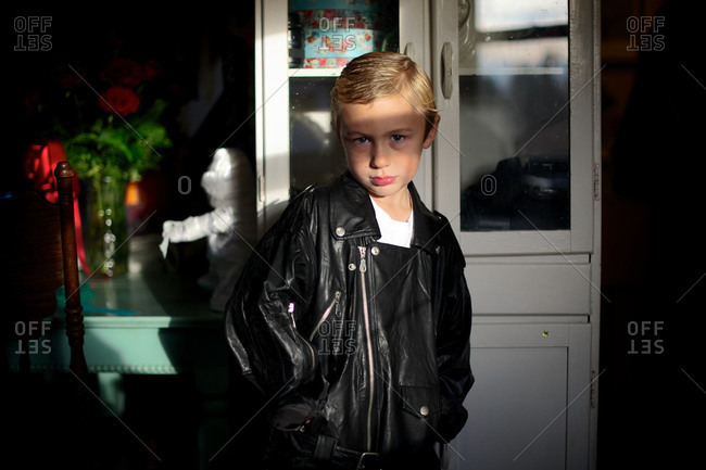 Young boy wearing a leather jacket