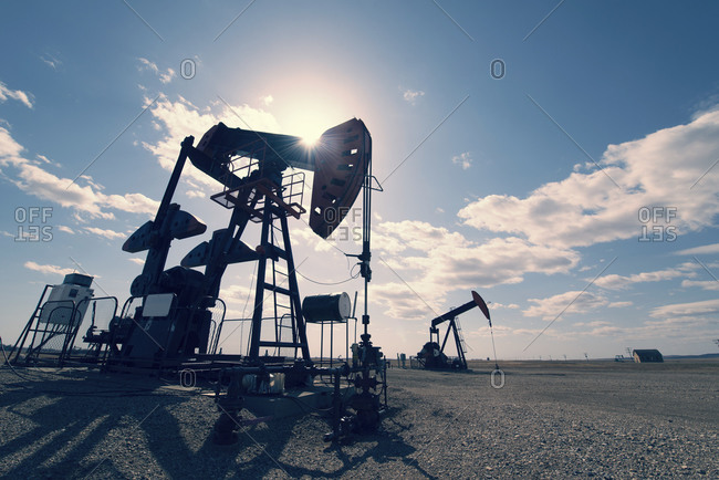 A pump jack in open ground at an oil extraction site