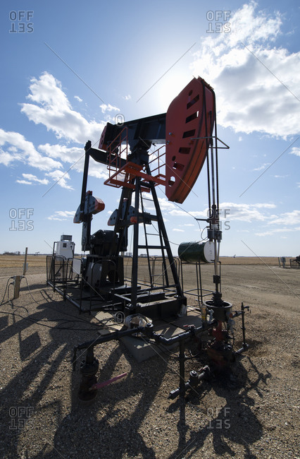 A pump jack in open ground at an oil extraction site