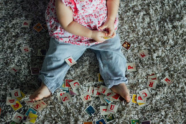 Young girl playing with flesh cards