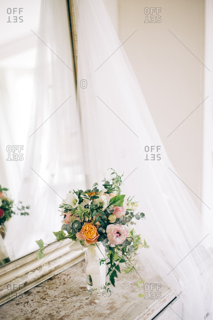 Floral arrangement on hall table with mirror