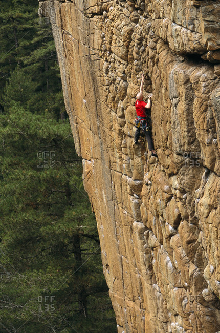 A rock climber scaling a cliff