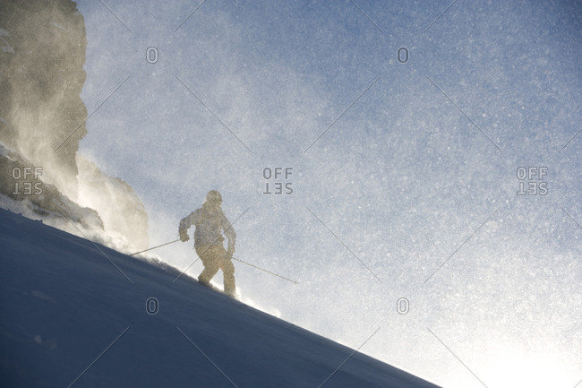 A Scandinavian man telemark skiing in powder snow, Switzerland