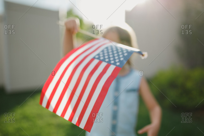 Close up of girl waving an American flag