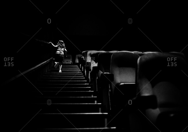 Girl walking up the stairs in a movie theater