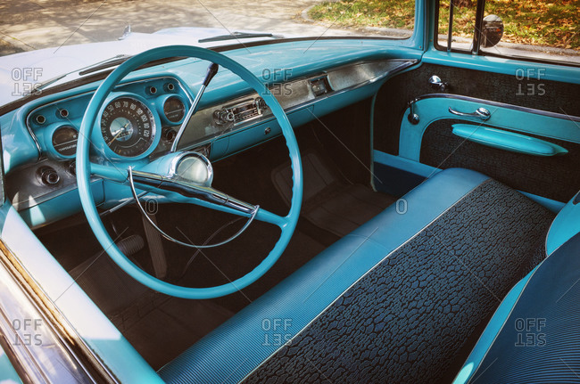 A turquoise steering wheel in a vintage truck