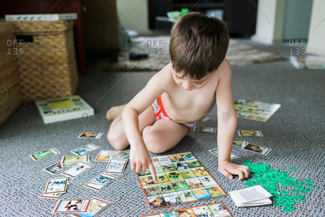 Boy on living room floor with memory game