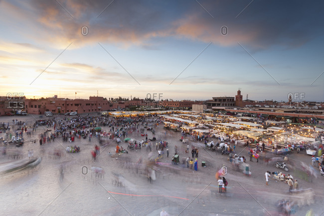 Jemaa al Fna square with crowds and food stalls at sunset Marrakesh, Morocco