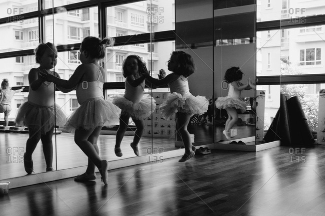 Little dancers watch themselves in a mirror