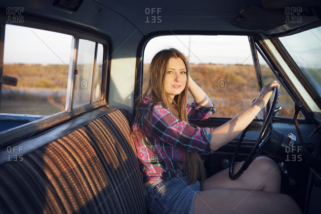 Young woman driving a pick up truck