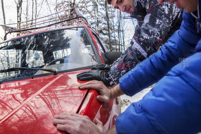 Two men pushed car ona  snow mountain road, Stolovi mountain, central Serbia