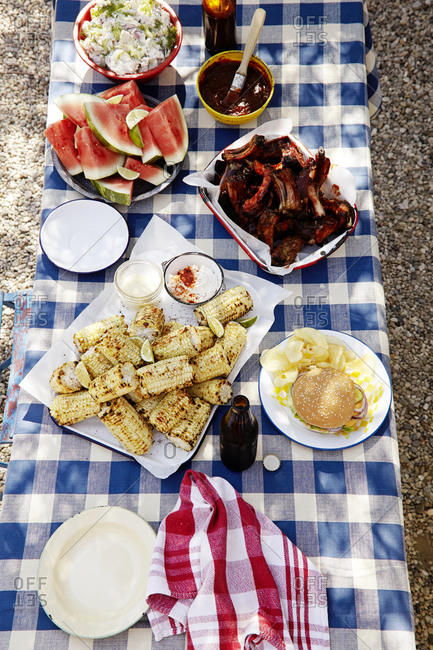 A picnic table covered with food