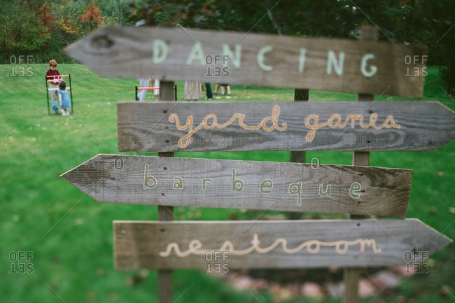 Outdoors signs pointing to wedding reception activities