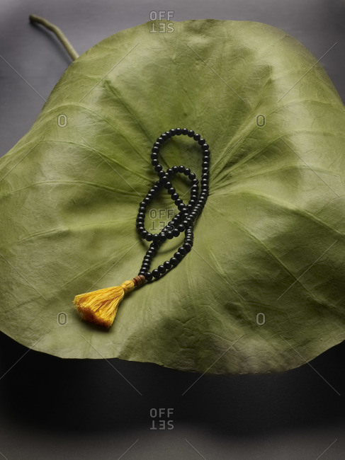 Prayer beads on a lotus leaf