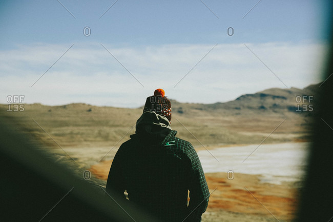 Man standing in remote setting staring