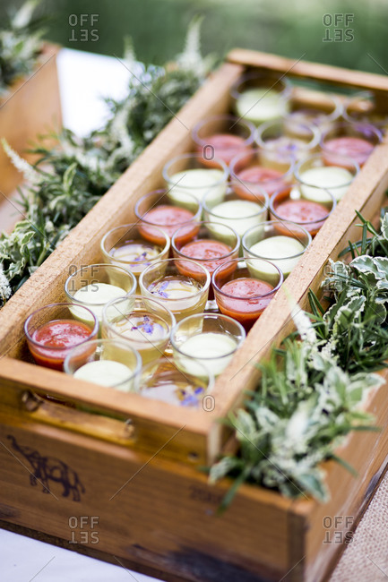 Tray of shot glasses of chilled soups at a wedding reception