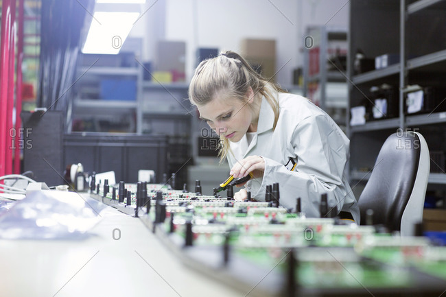 Technician working on circuit boards