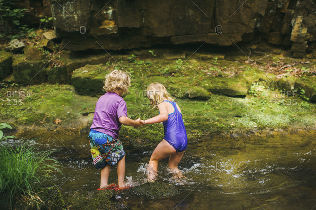 Children standing in a brook
