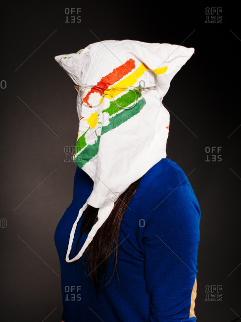 Woman sitting with bag over head