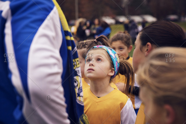 Girl listening to coach during soccer game