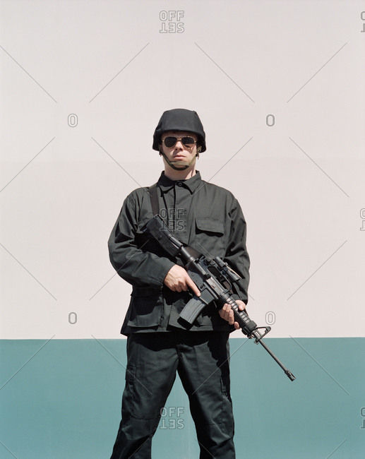 Single special ops soldier holding high powered rifle