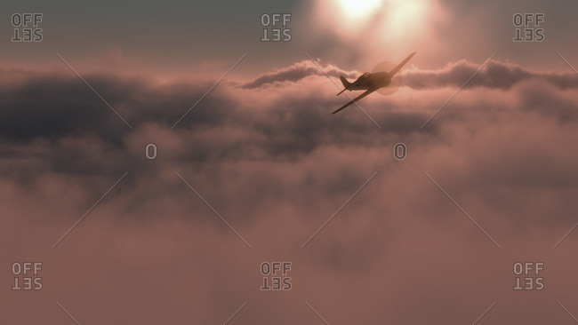 Small plane flying above pink clouds at sunset with the bright fiery orb of the sun in the background