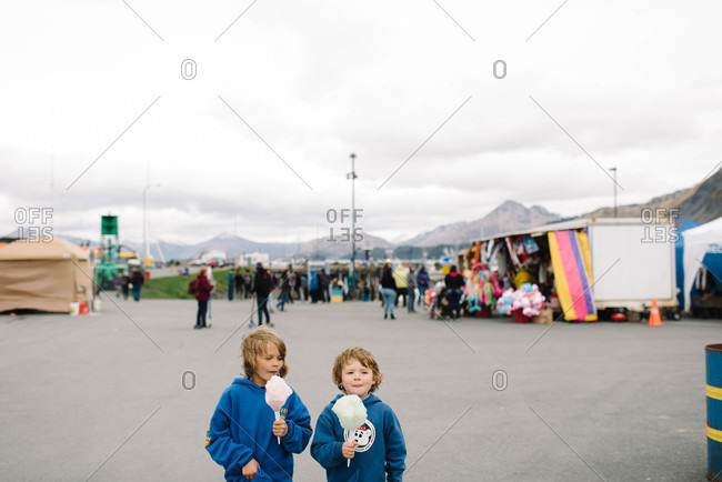 Children eating cotton candy at a county fair