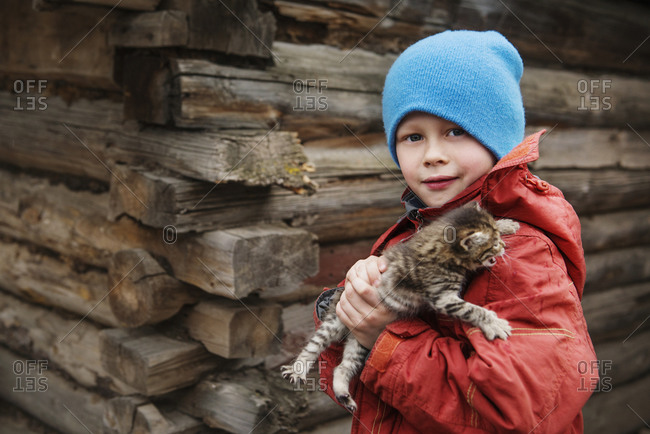 Little boy holding a kitten in Sparks Lake, Central Oregon
