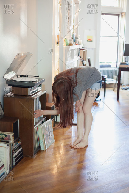 Woman choosing a record album from a shelf