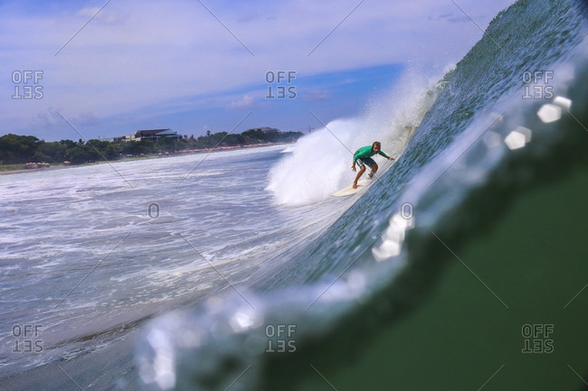Surfer in the tube getting barreled, Bali