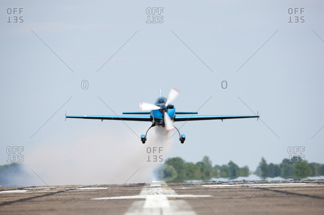 Small airplane landing on a runway