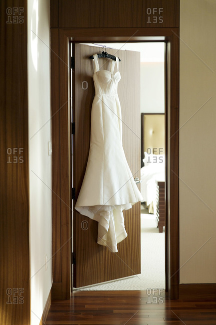Wedding dress hanging on a door